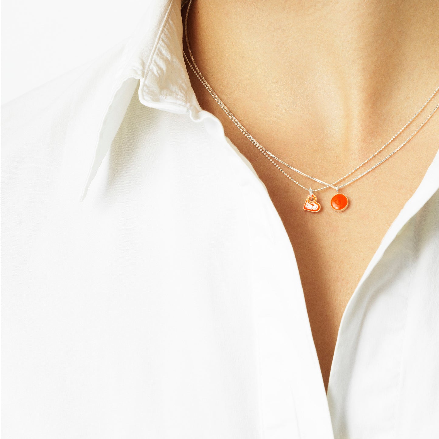 Sign necklace with pendant. Neon orange. Sterling silver. Scherning Copenhagen